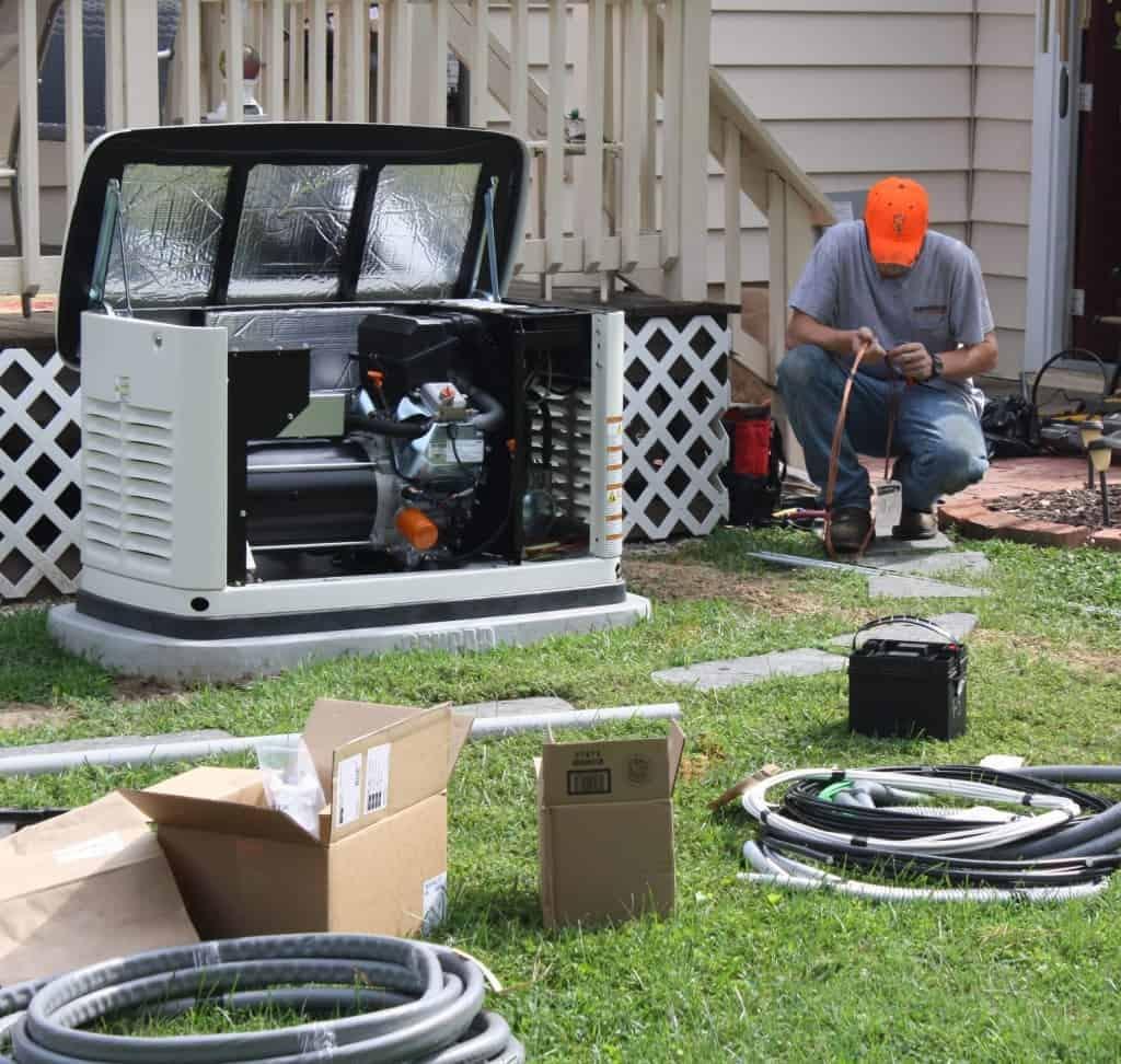 Backup generator installed beside an East Alabama home with transfer switch